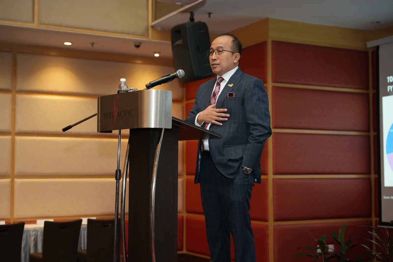 A speaker addressing delegates from the podium